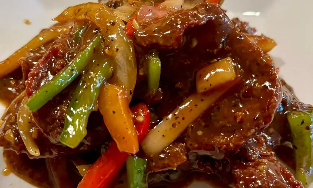 Tender beef in savory black pepper sauce with colorful peppers and onions at Hot Wok Cafe, a Chinese Restaurant in Greens West Windsor Township